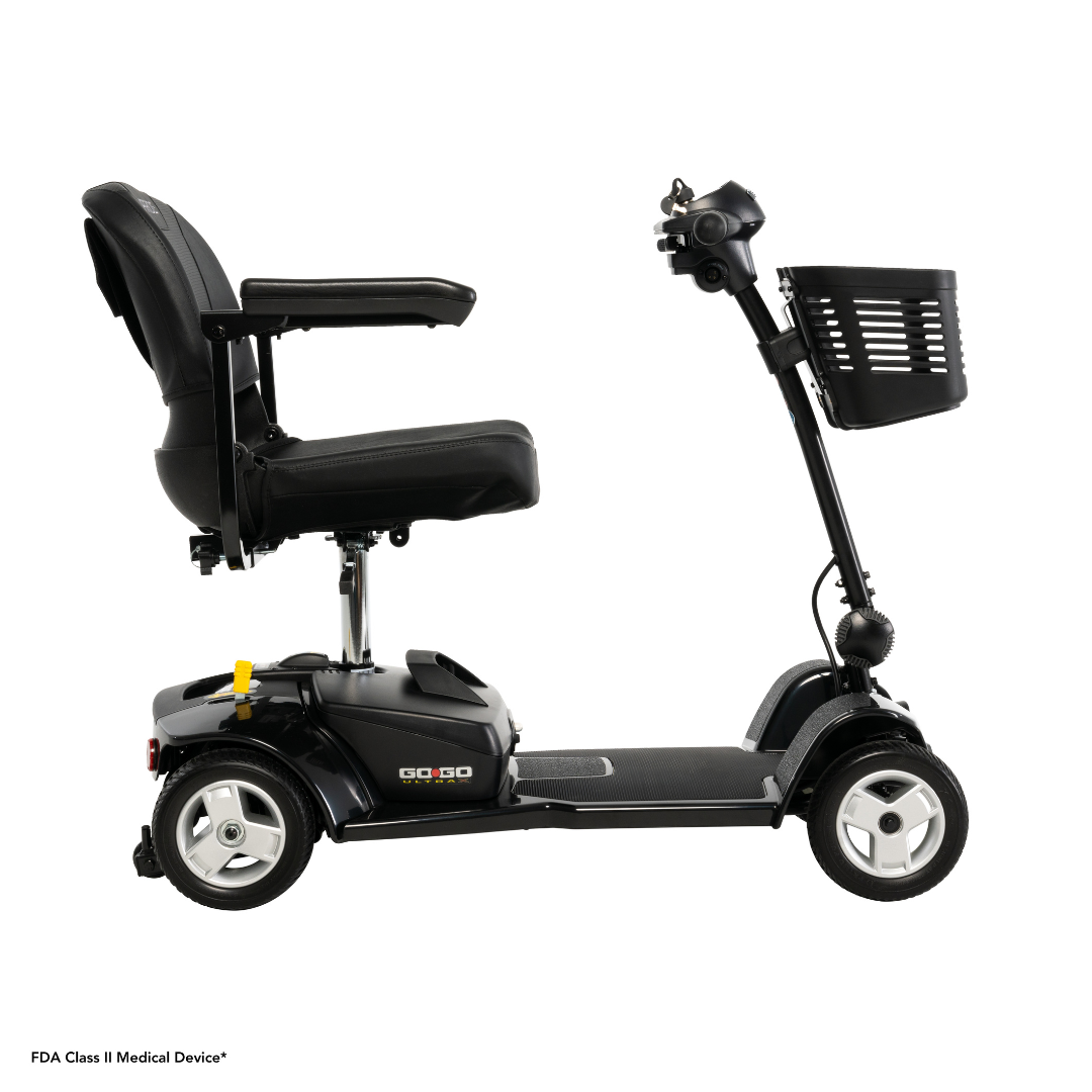 The Pride Mobility Go Go® Ultra X 4-Wheel Scooter in black features a cushioned seat, armrests, handlebars, and a front basket. Go-Go graces its rear. Set against a white background, this affordable mobility scooter offers comfort and style for every adventure.