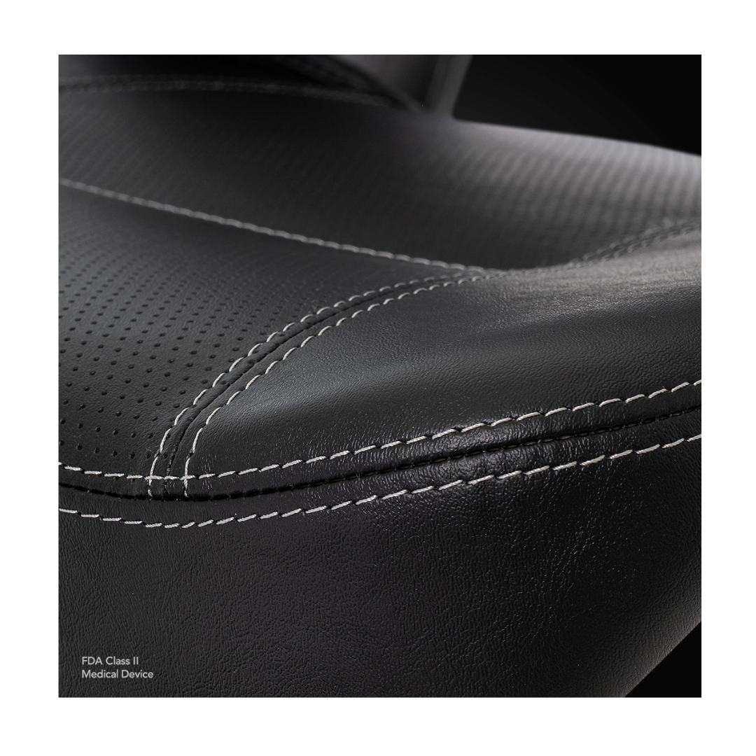 The image shows a close-up of black leather with white stitching on the Pride Mobility Go Go® Ultra X 4-Wheel Scooter seat, highlighting detailed textures and perforated leather. The corner text states FDA Class II Medical Device.