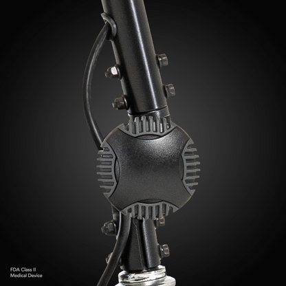 Close-up of a black Pride Mobility Go Go® Ultra X 4-Wheel Scooter, labeled as an FDA Class II Medical Device with a central cylindrical component and attached cables, showcasing design efficiency similar to economy-class scooters against a dark background.