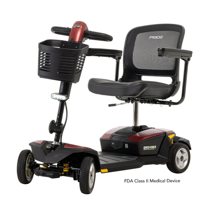 The Pride Mobility Go Go® Endurance Li 4-Wheel Scooter, a red and black mobility aid with Comfort-Trac Suspension, includes front basket storage. It has a padded seat with armrests and is labeled as an FDA Class II Medical Device for added stability.