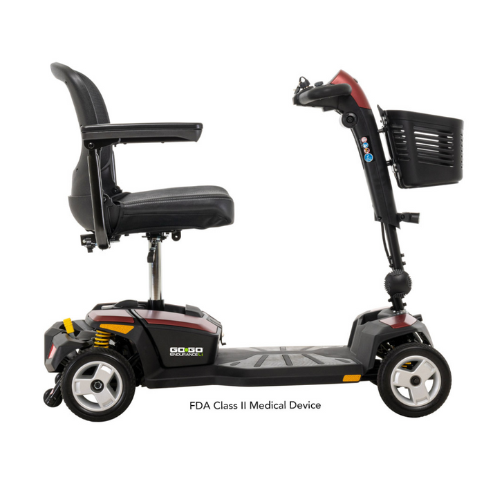 The Pride Mobility Go Go® Endurance Li 4-Wheel Scooter, in red and black, offers a cushioned seat, handlebar controls, a reliable lithium battery, Comfort-Trac Suspension for smooth rides, and a convenient front basket. Its designed for easy maneuverability as an FDA Class II Medical Device.