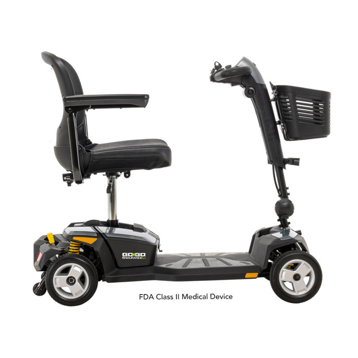 Side view of a Pride Mobility Go Go® Endurance Li 4-Wheel Scooter in black, featuring Comfort-Trac Suspension, a cushioned seat with armrests, a front basket, and four sturdy wheels. The base displays FDA Class II Medical Device.