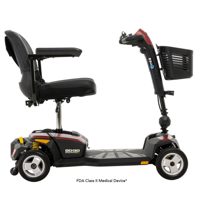 A side view of a black Pride Mobility Go Go® Endurance Li 4-Wheel Scooter with Comfort-Trac Suspension and red trim, featuring a front basket, padded seat with armrests. Its a 4-wheel FDA Class II Medical Device.