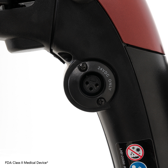 Close-up of a handle on the Pride Mobility Go Go® Endurance Li 4-Wheel Scooter showing a circular 24VDC ONLY power port. The black handle has red accents and a textured grip, with labels indicating its medical device classification.