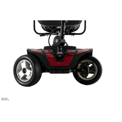 Close-up of the front wheels and lower frame of the red Pride Go Go® Sport 4-Wheel Scooter, showing its suspension, tires, and part of the seat. Shot on a white background, perfect for responsive grid layouts.