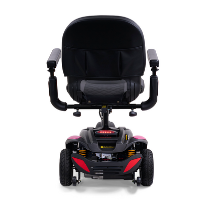 A rear view of a black and red luxury mobility scooter showcases a padded seat with armrests. The Golden Buzzaround LX GB119 - Heavy Duty 3 Wheel Portable Mobility Scooter exhibits its compact design from the back angle.