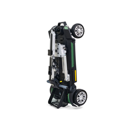 The Golden Technologies Portable Buzzaround GB120 Carry-On Travel Scooter is a fold-flat electric scooter that stands upright to highlight its compact design. It features a sleek black and green color scheme, sturdy wheels, and a metallic frame with an ultra-portable build, making it ideal for easy storage. Powered by a lithium-ion battery, it's perfect for on-the-go convenience.