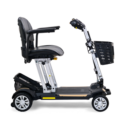 Side view of the Golden Technologies Portable Buzzaround GB120 Carry-On Travel Scooter, a black mobility scooter featuring a comfortable seat, armrests, and a front basket. This ultra-portable design is compact with four wheels for stability and includes a fold-flat option powered by a reliable lithium-ion battery for added convenience.