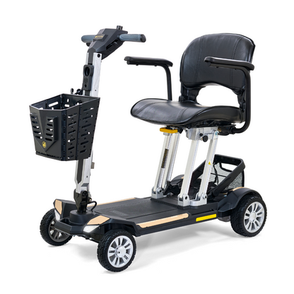 The Golden Technologies Portable Buzzaround GB120 Carry-On Travel Scooter is a black electric mobility scooter that boasts a sturdy seat, armrests, and a front basket. Its sleek, fold-flat design makes it ultra-portable, and it features four wheels along with a lithium-ion battery for ideal personal transportation.