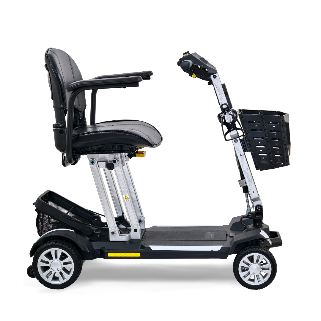 The Golden Technologies Portable Buzzaround GB120 Carry-On Travel Scooter is an ultra-portable mobility scooter featuring a black leather seat, armrests, four wheels, a metallic frame, and a small front basket. Designed for easy transport and maneuverability, it includes a fold-flat design powered by a lithium-ion battery.