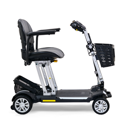 The Golden Technologies Portable Buzzaround GB120 Carry-On Travel Scooter is an ultra-portable mobility scooter featuring a black leather seat, armrests, four wheels, a metallic frame, and a small front basket. Designed for easy transport and maneuverability, it includes a fold-flat design powered by a lithium-ion battery.