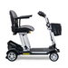The Golden Technologies Portable Buzzaround GB120 Carry-On Travel Scooter is an ultra-portable mobility scooter featuring a black leather seat, armrests, four wheels, a metallic frame, and a small front basket. Designed for easy transport and maneuverability, it includes a fold-flat design powered by a lithium-ion battery.