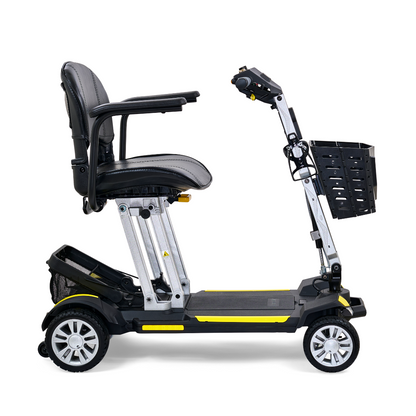 Introducing the Golden Technologies Portable Buzzaround GB120 Carry-On Travel Scooter, a sleek black and yellow mobility solution. It boasts a cushioned seat and a convenient basket attached to the front handlebar. Designed for stability with four wheels, this scooter features a foldable design for easy transport and is powered by a lithium-ion battery for extended use.
