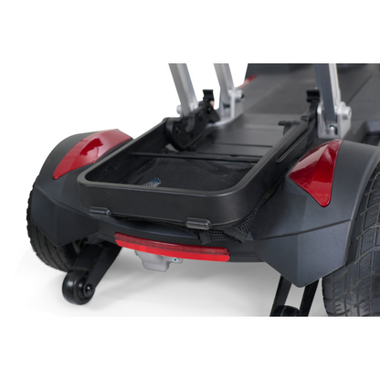 Image showcasing the rear section of the Golden Technologies Portable Buzzaround GB120 Carry-On Travel Scooter, featuring two large wheels and a central open storage compartment. This fold-flat scooter sports a sleek black design with red accents, offering a sturdy and functional build. It comes equipped with an ultra-portable lithium-ion battery, ideal for easy travel.