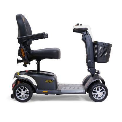 Experience seamless travel with the Golden Buzzaround LX GB149, a heavy-duty 4-wheel portable mobility scooter. It offers comfortable rides with a cushioned seat, armrests, and a front basket. The sleek black and gray design with yellow accents is complemented by small wheels and an adjustable tiller for smooth personal transportation.