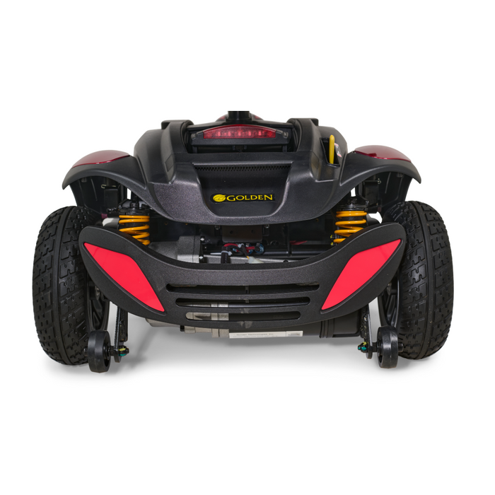 Rear view of the Buzzaround LX GB149, a heavy-duty black and red portable mobility scooter from Golden, showcasing an adjustable tiller, large tires, yellow springs, and the brand's signature on the back panel. Its sleek and sporty design makes it stand out among portable travel scooters.
