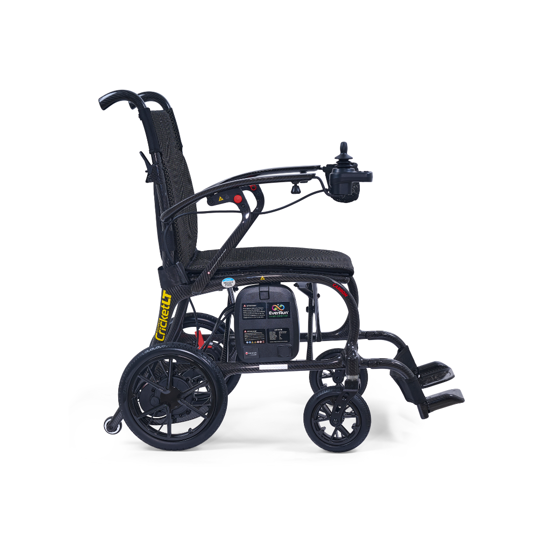 The Golden Cricket™ LT Carbon Portable Lightweight Powerchair (25 lbs) in black features a padded seat, right-armrest joystick, large rear wheels, and footrests, offering exceptional freedom. Shown side view on a white background.