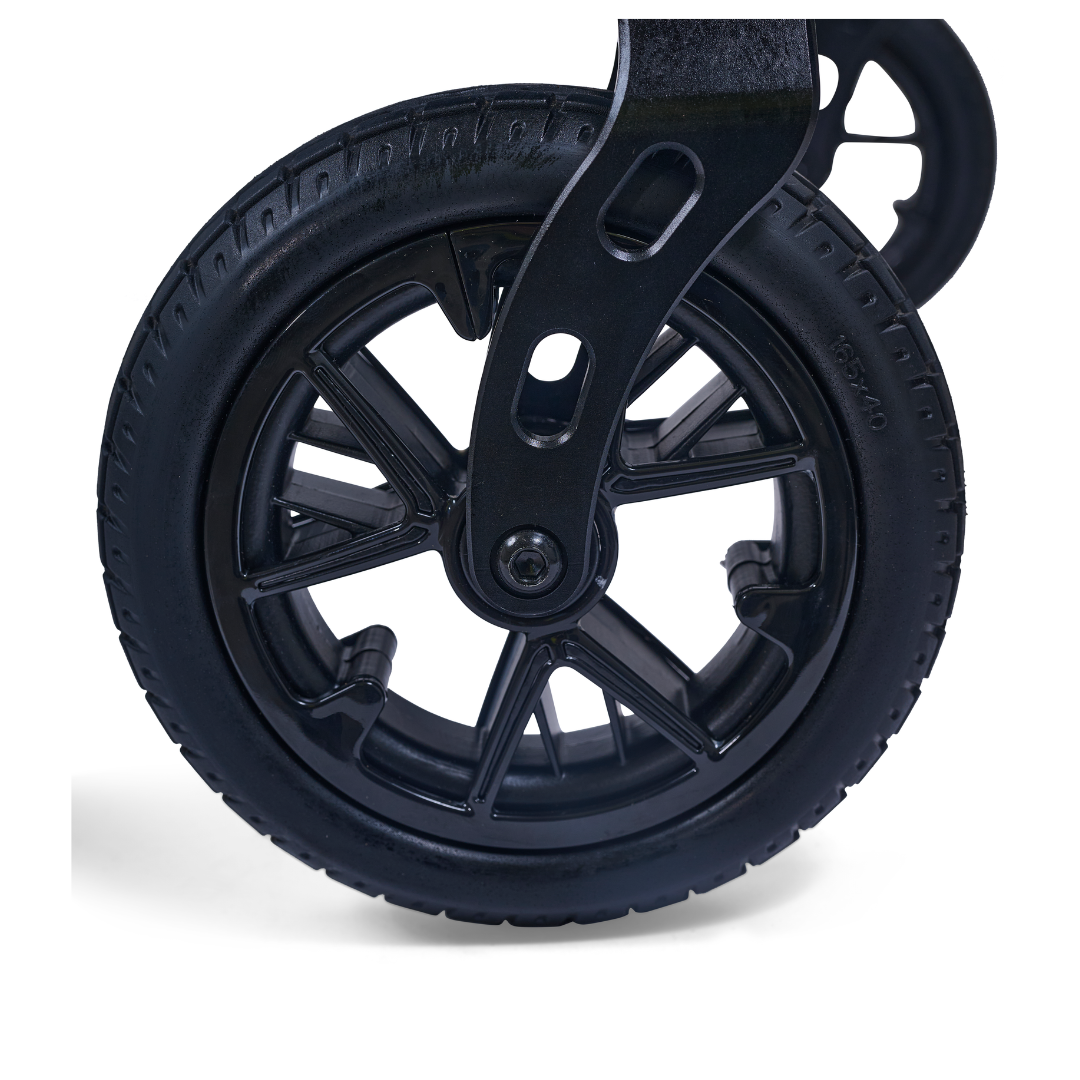 Close-up of a black rubber wheel with spokes, attached to the Golden Cricket™ LT Carbon Portable Lightweight Powerchair (only 25 lbs), highlighting its smooth mobility and maneuverability against a white background.