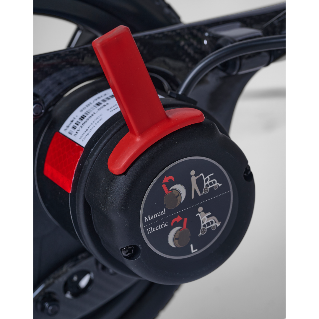 Close-up of the Golden Cricket™ LT Carbon Powerchair’s control switch with red lever—choose Manual or Electric mode for unmatched freedom. Inspired by its 25 lb lightweight carbon design, this switch offers precise, reliable performance.