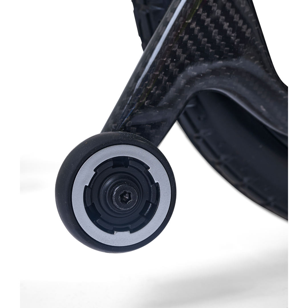 Close-up of a small black and gray wheel attached to the Golden Cricket™ LT Carbon Portable Lightweight Powerchair (only 25 lbs), highlighting its exceptional maneuverability against a white background.
