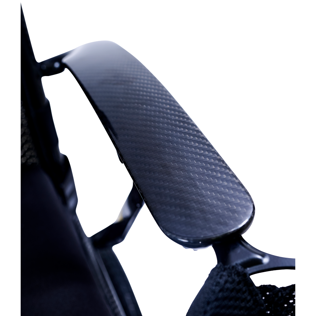 Close-up of the Golden Cricket™ LT Carbon Portable Lightweight Powerchair (only 25 lbs) shows its black carbon armrest with a smooth, glossy finish and subtle woven pattern, highlighting the lightweight carbon design and dark frame.