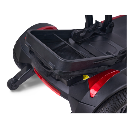 Close-up of the Golden Buzzaround GB220 CarryOn HD Travel Scooters rear shows an open storage compartment above the rear wheel, featuring red accents and black mesh lining inside.