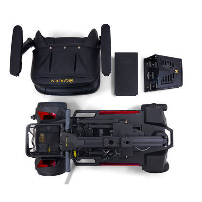 Top-down view of the disassembled Golden Buzzaround GB220 CarryOn HD Travel Scooter, showing the seat, battery, rear wheel section, and chassis neatly arranged on a white background.