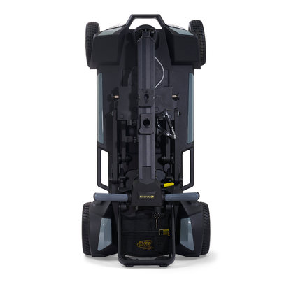 A top-down view of the Golden Buzzaround GB220 CarryOn HD Travel Scooter, folded and standing upright on its rear wheels, displaying the underside, wheelbase, and an attached storage bag at the bottom.