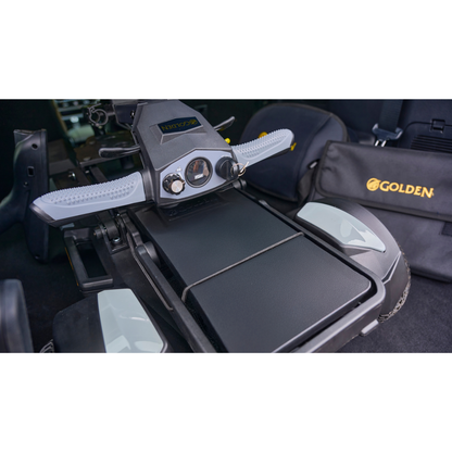 Close-up of the control panel and armrests of the Golden Buzzaround GB220 CarryOn HD Travel Scooter, with a black Golden-branded carrying case next to it.