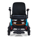The Golden Tech Ally Pro Smart All-Terrain Power Wheelchair features omni-directional wheels, a black seat and backrest, teal frame accents, red suspension springs, a joystick on the right armrest, and a footrest at the bottom.