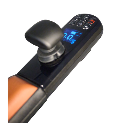 Close-up of the Golden Tech Ally Pro Smart All-Terrain Power Wheelchairs control panel showing 7.0 MPH on a blue-lit digital screen, reflecting advanced robotics technology, with buttons for speed and settings and a safety key slot. The frames black and brown colors exude modern elegance.