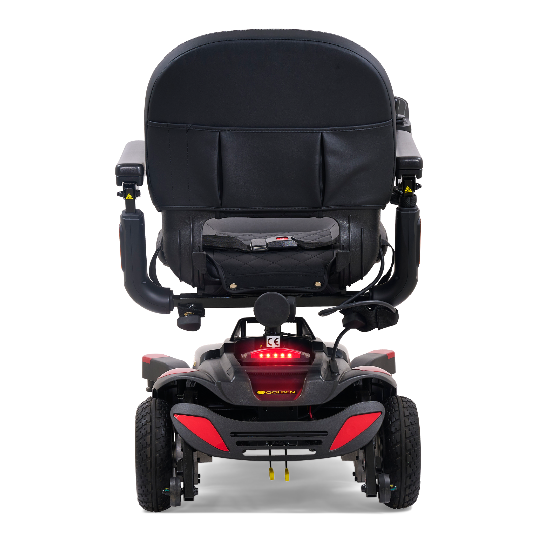 Rear view of the Golden Tech BuzzAbout Portable Power Wheelchair in black, featuring four wheels, padded seat and backrest, armrests, and rear red reflector lights—perfect for comfort and mobility in a compact power chair.