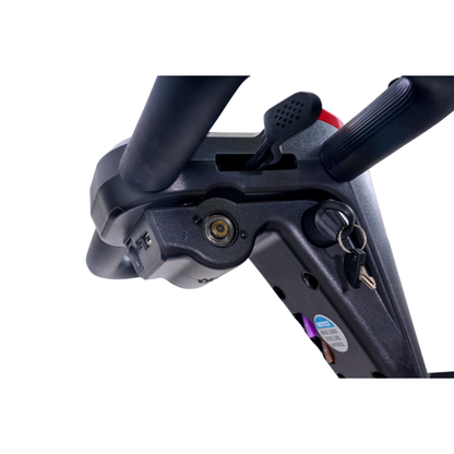 Close-up of the ignition area on a Golden Tech Buzzaround GB152 XL+ 4-Wheel Mobility Scooter, showing a key in the lock, lever, handlebar tubes, and control panel with labeled buttons.