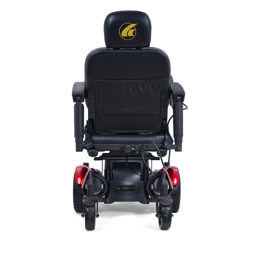 A rear view of the Golden Tech GP620 Compass HD Bariatric Electric Wheelchair shows a black headrest with a gold logo, armrests, red rear lights, and large rear wheels.