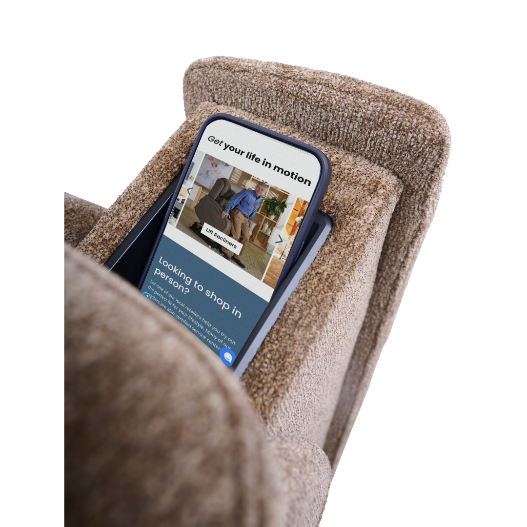 A smartphone displaying a shopping website sits in the armrest slot of a brown Golden Tech Halo Power Lift Recliner with Footrest Extension & power Headrest.