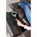 Lounging on the Golden Cloud+ PR511 Recliner with Lift Assist - Medium Wide, this person, in jeans and a pink sweater, enjoys ultimate relaxation from the 4-Zone Comfort Zone. They effortlessly grab a TV remote from a built-in compartment near a turquoise mug under cozy soft lighting.