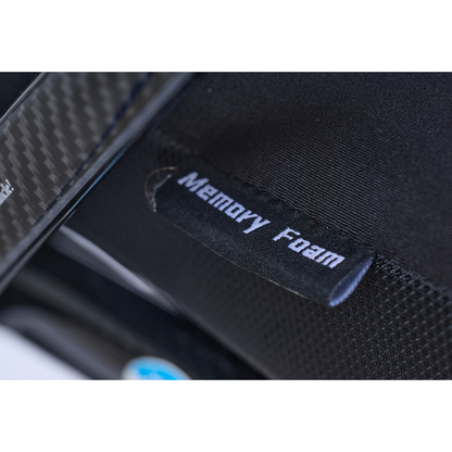 Close-up of a black fabric tag labeled Memory Foam attached to a textured black surface, likely part of the Golden Cricket™ LT Carbon Portable Lightweight Powerchair, which weighs only 25 lbs.