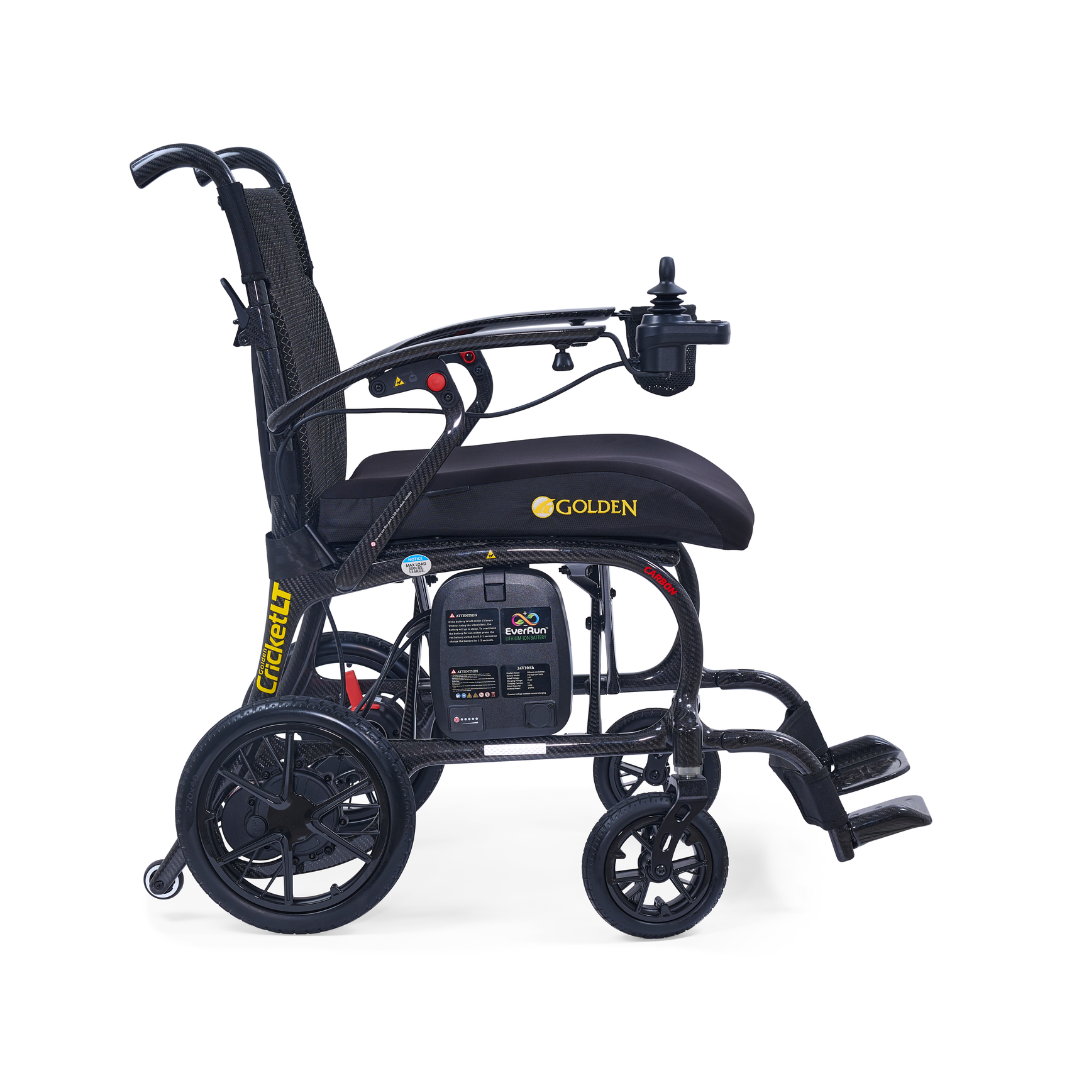 A side view of the Golden Cricket™ LT Carbon Portable Lightweight Powerchair (only 25 lbs) in black, featuring joystick controls, small front wheels, larger rear wheels, and footrests.