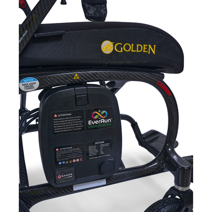 Close-up of the Golden Cricket™ LT Carbon Portable Lightweight Powerchair (only 25 lbs), featuring a visible Golden logo, EverRun lithium-ion battery, and a max load notice of 136 kg (300 lbs), with part of one wheel also in view.