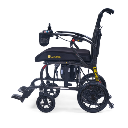 Side view of the Golden Cricket™ LT Carbon Portable Lightweight Powerchair in black and yellow, with joystick control, cushioned seat, footrests, large rear wheels, branded frame, and weighing only 25 lbs.