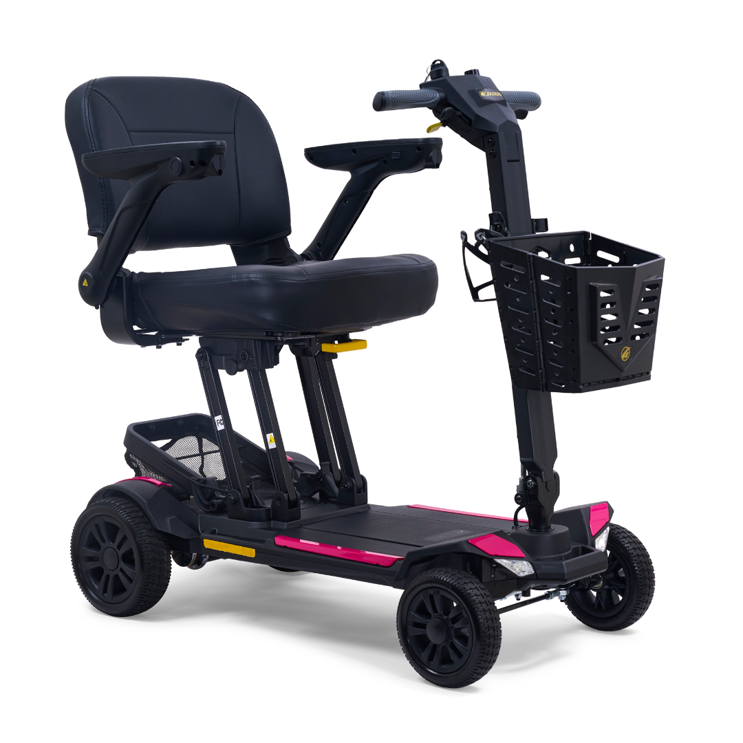 The Golden Buzzaround GB220 CarryOn HD Travel Scooter with FREE Extra Battery is a black, lightweight, four-wheel scooter with pink base accents, padded seat, armrests, handlebar controls, front basket, and supports up to 400 lbs.