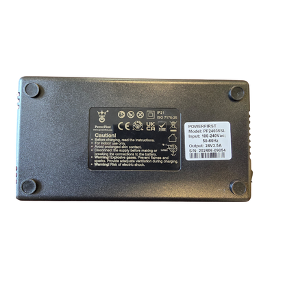 The Golden Tech 3.5 AMP Replacement Charger for scooters and power chairs is a rectangular black device with four rubber corner feet and a label showing caution instructions, technical specs, and power ratings.