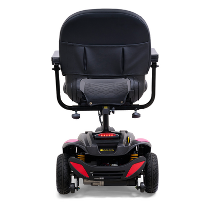 Rear view of the Golden Tech GB118 Buzzaround EX Portable Mobility Scooter with a black padded seat and backrest. This full-size scooter has four wheels, a sturdy frame, and control handles on each armrest for accessibility and comfort.
