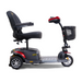 The Golden Tech GB118 Buzzaround EX Portable Mobility Scooter is a full-size, four-wheel scooter with black seating and armrests, a front black basket, striking red frame accents, and an intuitive control handlebar for effortless personal transportation.