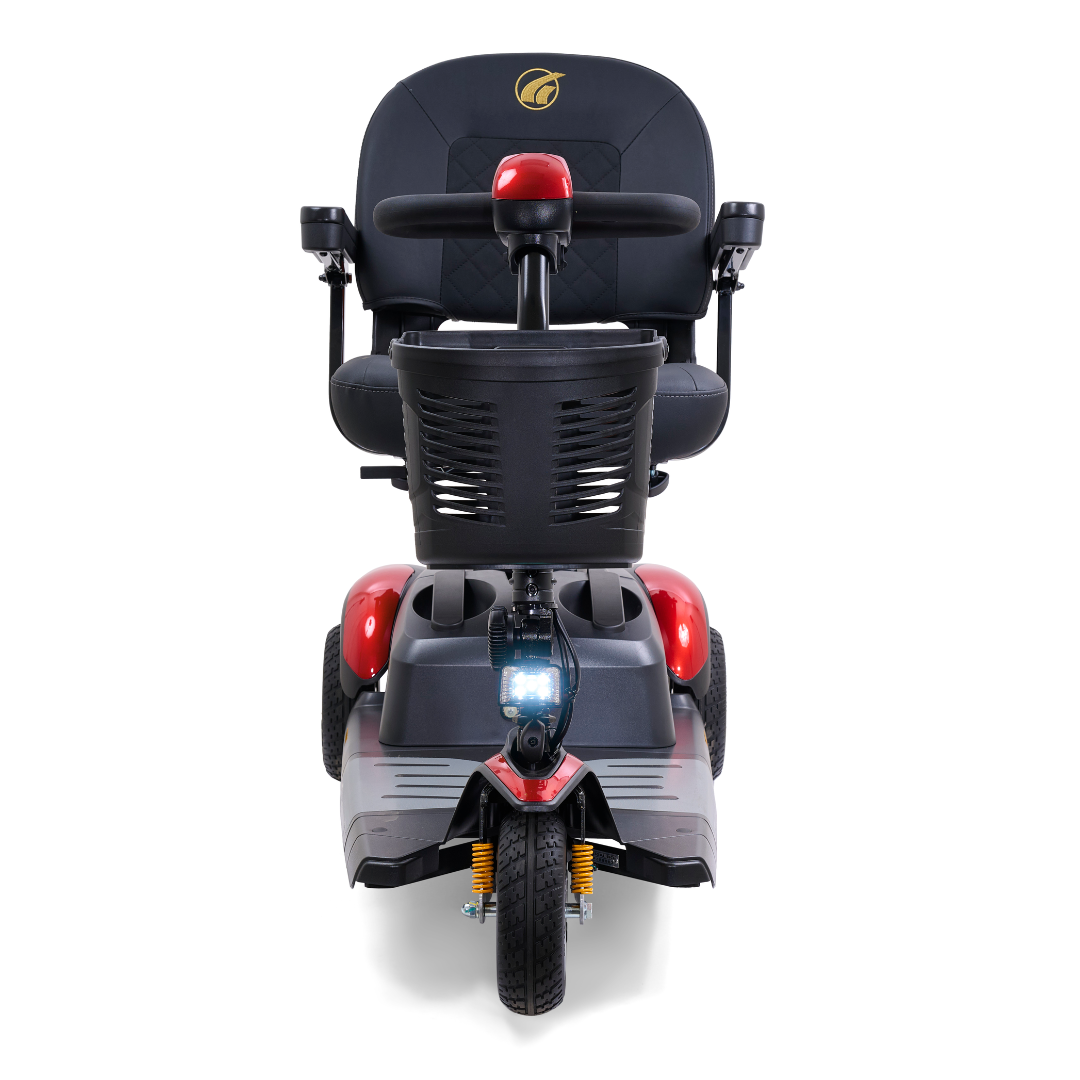 Front view of a red Golden Tech GB118 Buzzaround EX Portable Mobility Scooter with a black seat and basket, featuring a single front wheel, headlight, and logo on the headrest.