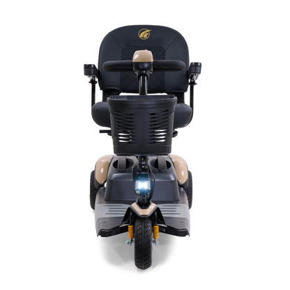 The Golden Tech GB118 Buzzaround EX Portable Mobility Scooter features a beige frame with a black seat and handlebars, three wheels, a grid-design front basket, visible suspension springs for comfort, and a central headlight.
