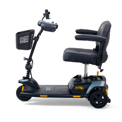 Side view of a black Golden Tech GB121 Buzzaround XLS HD scooter with cushioned seat, armrests, and a front basket. This 3-wheel model offers Comfort Spring Suspension for smooth rides, stable design, handlebar controls, and displays the brand logo on the base.