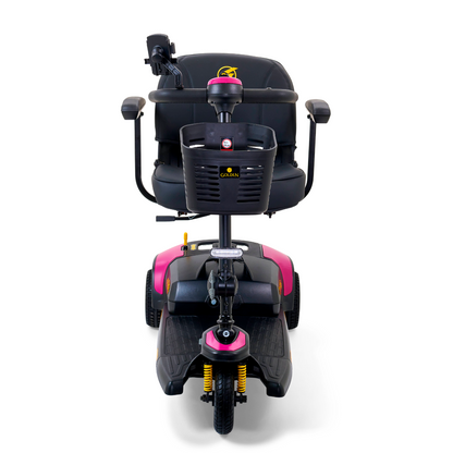 The Golden Tech GB121 Buzzaround XLS HD 3-Wheel Portable Scooter showcases a pink and black design with a stadium seat, armrests, handlebars, and front basket. It supports up to 325 lb., features Comfort Spring Suspension, and is designed for easy maneuverability.