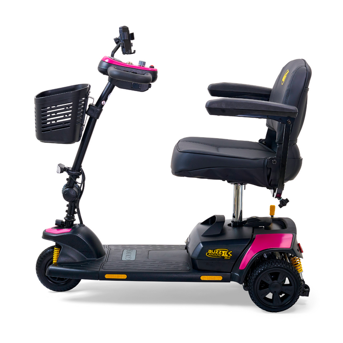 The Golden Tech GB121 Buzzaround XLS HD is a black and pink portable 3-wheel scooter with suspension. It includes an XR Extended Range Battery, padded seat with armrests, front basket, and handlebar controls, shown in side view against a white background.
