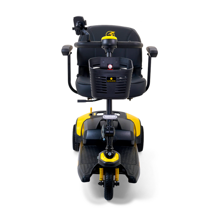 The Golden Tech GB121 Buzzaround XLS HD 3-Wheel Portable Scooter boasts a sleek black and yellow design, armrests, front basket, Comfort Spring Suspension, XR Extended Range Battery for smooth rides, and a handlebar-equipped steering column for easy navigation.